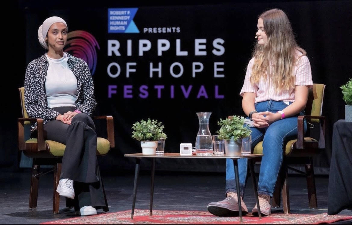 People sitting on a stage talking